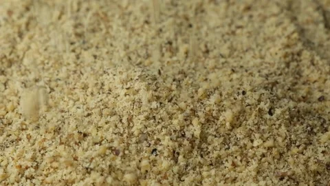 Macro crushed walnut kernels pour vertical slow motion Stock Footage 327378144