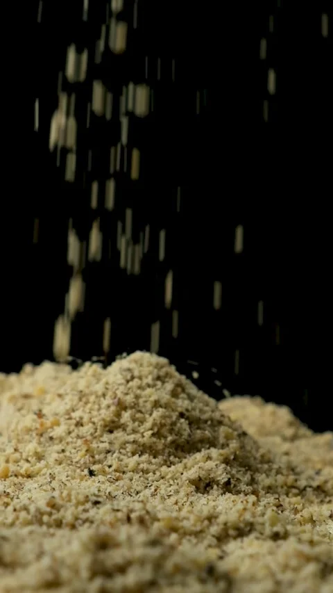 Macro crushed walnut kernels pour vertical slow motion Stock Footage 327378668