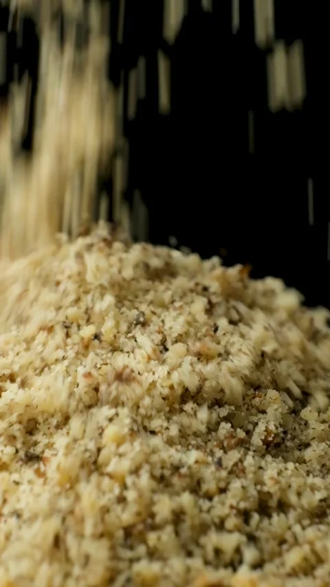 Macro crushed walnut kernels pour vertical slow motion Stock Footage 328009423