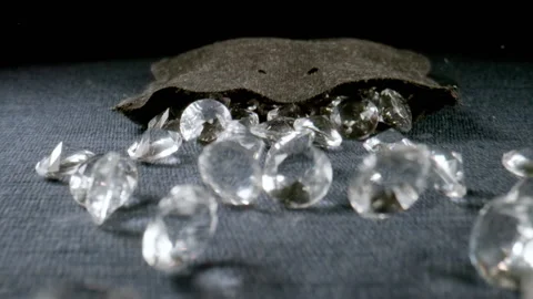 MACRO: Crystals fall out from a black sac on a table, slow motion Stock Footage 145825545
