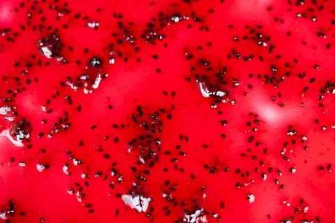 Macro currant jam glaze on plate, glossy ruby surface and tiny seeds creating el 库存照片