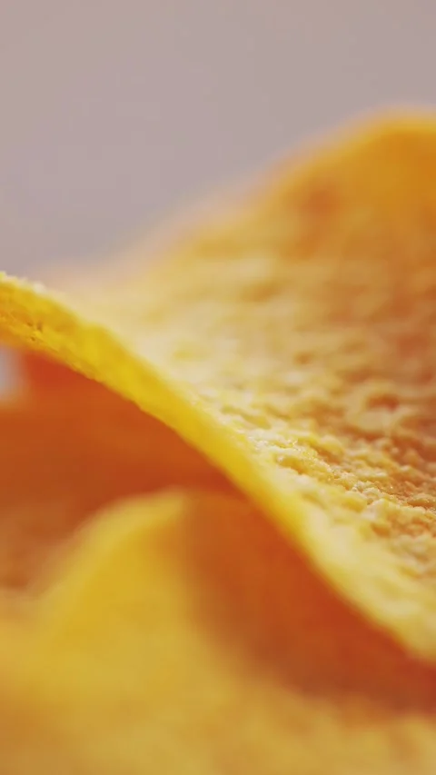 Macro of Curved Potato Chip Surface Warm Light Vertical Video Stock Footage 314925573