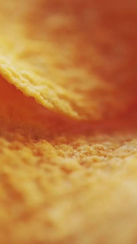 Macro of Curved Potato Chip Surface Warm Light Vertical Video Stock Footage 314925581