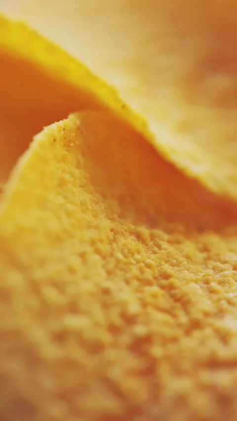 Macro of Curved Potato Chip Surface Warm Light Vertical Video Stock Footage 314925591