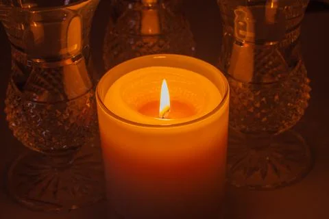 Macro defocused view of a candle flame illuminating nearby crystal Stock Photos