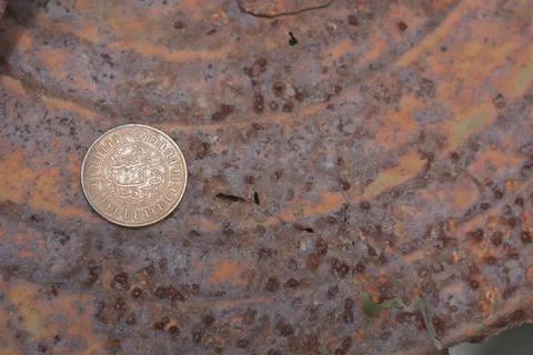 Macro Detail of Arabic Jawi Script on Antique Copper Coin Over Rust Stock Photos