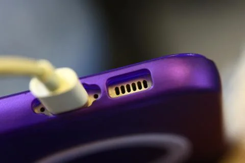Macro detail of a charging cable plugged into a smartphone. The image illustr Stock-Fotos