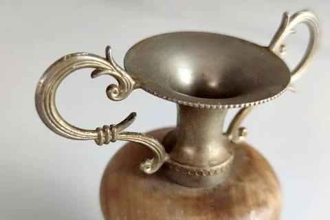 Macro detail of ornate scroll handle on antique vase Stock Photos