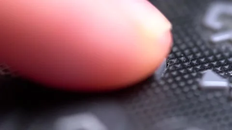Macro detail of the pause button on a remote control being pressed Stock Footage 133589036