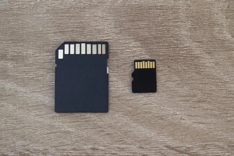 Macro detail of standard SD memory card and micro SD card on neutral surface. Stock Photos