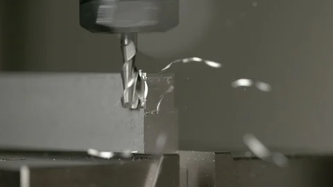 MACRO, DOF: Sharp end mill shaves the side of a small aluminium workpiece. Stock Footage 114056059