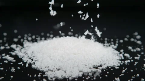 MACRO, DOF: Tiny shreds of grated coconut fall down on the empty kitchen table. Stock Footage 166539774