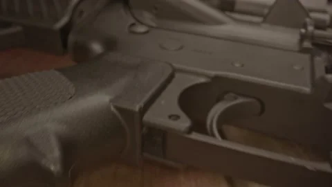 Macro dolly out from AR-15 assault rifle safety indicator and revealing a 库存影片 205260365