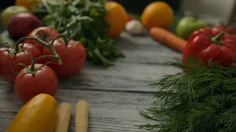 Macro dolly plan of rolling potato on wooden table Stock Footage 121583957