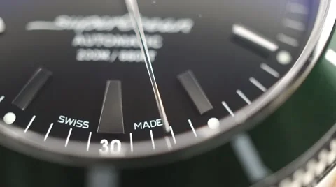 Macro dolly shot of second hand of luxury swiss made watch with green bezel Stock Footage 59065766