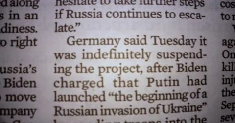 Macro dolly shot through article on war in Ukraine Stock Footage 179547575
