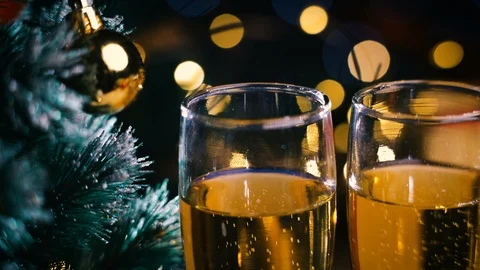 Macro Dolly Shot of Two Glasses Champagne Beside Christmas Tree. Dark Night B Stock Footage 96353216
