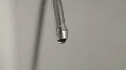 Macro, drops of clean drinking water dripping from a metal kitchen faucet Stock Footage 219721743