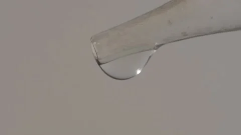 Macro of drops coming from an eyedropper Stock Footage 131314379