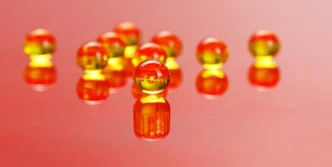 Macro of e vitamine pills on red Stock Photos