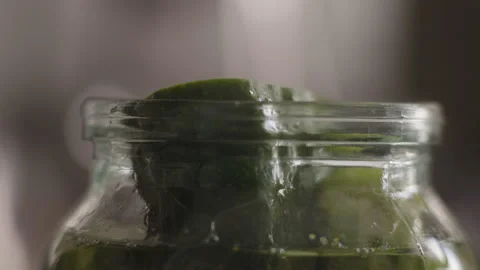 Macro, Elderly Woman's Hand Pours Boiling Water Into a Jar To the Edges and Stock Footage 158261231