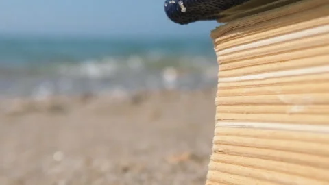 Macro Elegance: Vintage Book on Sandy Shore and sea waves Stock Footage 250469532