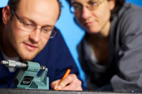 Macro of engineer recording measurements with assistant Stock-Fotos