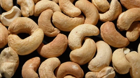 Macro Extreme Close-up of Rotating Roasted Cashew Nuts. Stock Footage 332837364