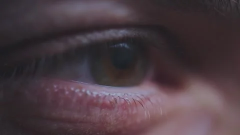Macro extreme close up shot of human eye blinking and pupil dilating in dim.. Stock Footage 337597654