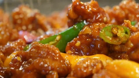 Macro Extreme Close-Up of Spicy Indo-Chinese Chilli Chicken with Fresh Green Chi Video stock 343027385