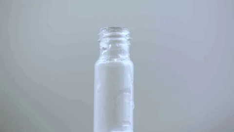 Macro eye dropper creates large plum of smoke in vile on white BG Stock Footage 70671847