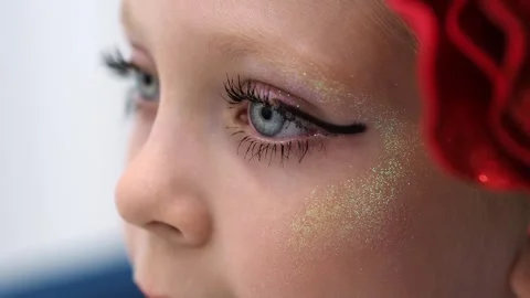 Macro eye with makeup. Bright theatrical makeup for the stage. The child is star Stock Footage 242589437