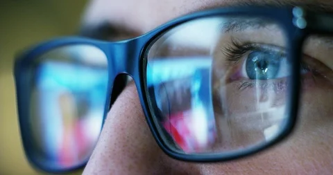 Macro of eyes with glasses of a web surfer or a workaholic while working. Stock Footage 115368978