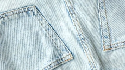Macro fabric texture of classic blue jeans. Pockets and thread stitching Stock Footage 310605312