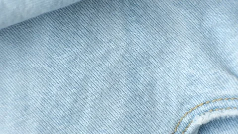 Macro fabric texture of cotton blue jeans. Pocket and thread stitching Stock Footage 312053306