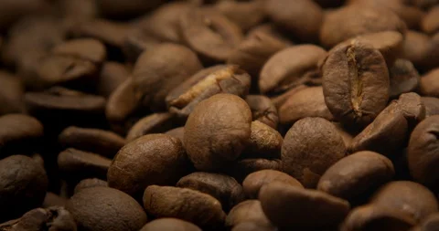 Macro of falling coffee beans 스톡 동영상 129757779