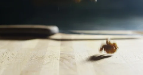 Macro of falling nuts on wooden table in professional restaurant kitchen Stock Footage 115308706