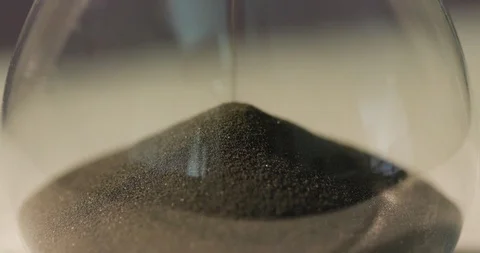 Macro falling sand at the bottom of an hourglass Stock Footage 115086010