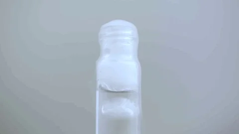 Macro fast bubbling vile with smoke on white BG Video stock 70672646