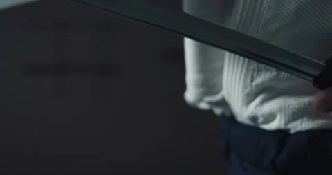 Macro of fighter master pulling out katana sword in martial arts school. Stockbeeldmateriaal 154024959