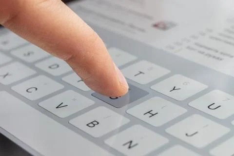 A macro of a finger typing text on the touch screen keyboard of mobile device Stock Photos