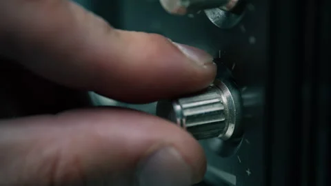 Macro fingers touching knobs radio player. Unrecognizable man regulating volume Stock Footage 332363277