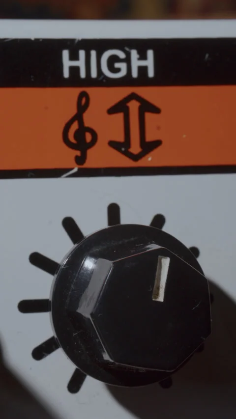 Macro of Fingers Turning High Equalizer Knob on Guitar Amplifier Stock-Footage 342454254