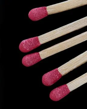Macro of five matches isolated on a black background Stock Photos