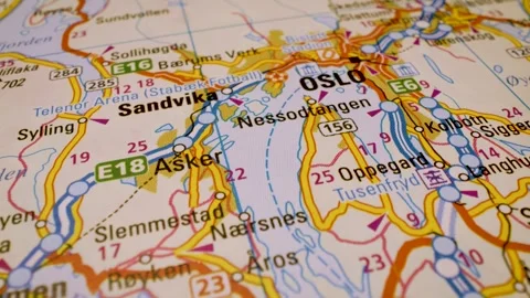Macro flight to oslo, norway, across detailed road atlas map Stock Footage 341269495