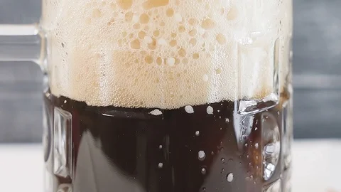 Macro of foam with bubbles of pouring beer. Slow motion. Stock Footage 123538103