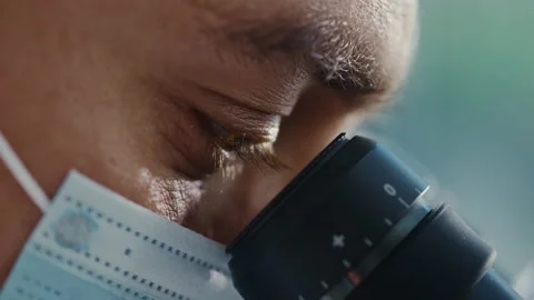 Macro Footage Scientist Using Microscope in Laboratory Stock Footage 146068231
