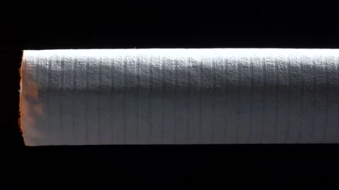 Macro footage of smoldering cigarette on black background Video stock 120959601