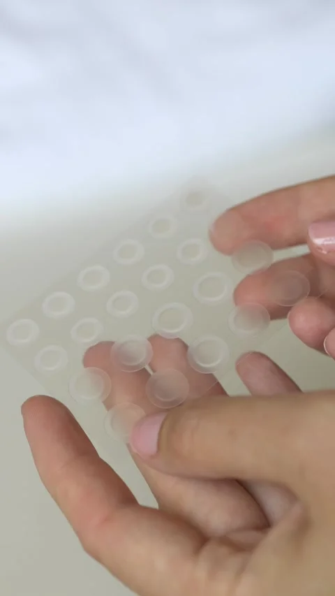 Macro footage of transparent pimple patches for acne recovery and healthy skin Stock Footage 336408024
