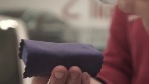 Macro frame close-up of a bottle dripping transparent liquid onto a rag. Footage Vidéo 143452857